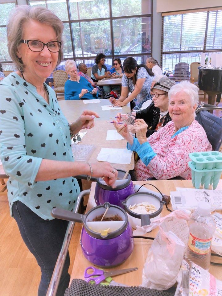 Volunteers who serve directly at a local care facility assist Helpertunity and the Activity Staff with a new Candy Making Class 
